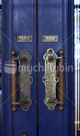 brass handles on blue doors