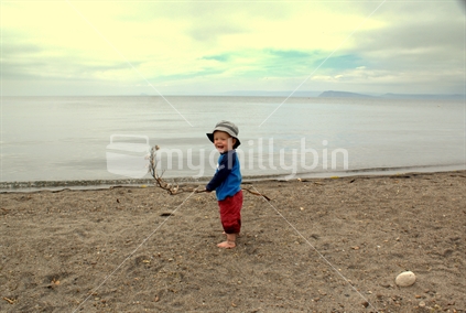 Boy Playing with Flax at Lake Taupo, New Zealand.