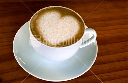 A heart-shape appears in the froth atop a latte