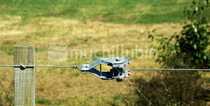 Close-up of wire fence with tensioner,