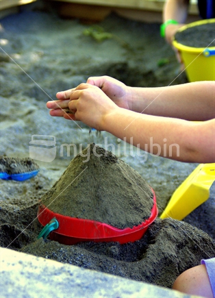 children play in a sandpit