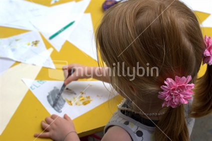 A young girl starts a painting