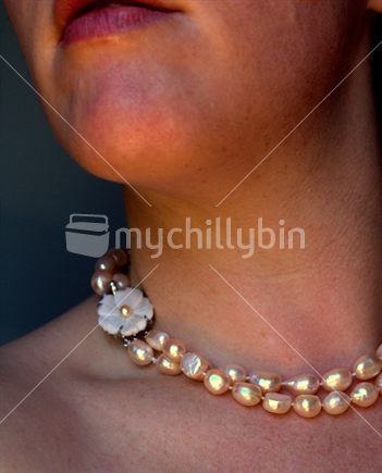 Pearl necklace worn by woman