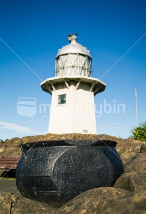 Old lighthouse in Wairoa with whaling pot in foreground