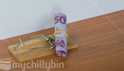 Fifty dollar note set as bait in a mousetrap