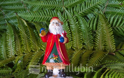Santa Claus figurine on a fern background