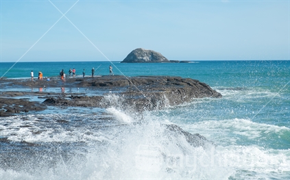 People fishing off a rock, Fishermans Rock, Muriwai