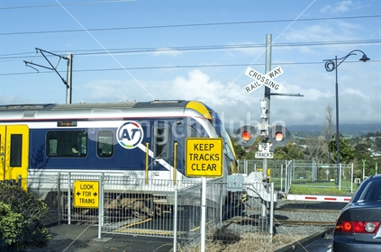 AT Commuter train at a level crossing
