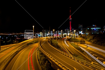 Auckland motorway traffic with CBD and the Sky Tower in the background.