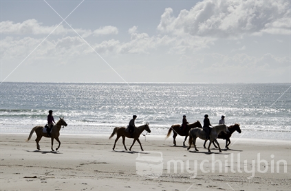 Horses running on beach