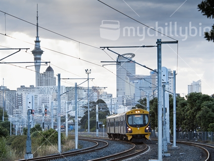 Passenger train leaving Auckland terminal, showing new electification wiring and poles