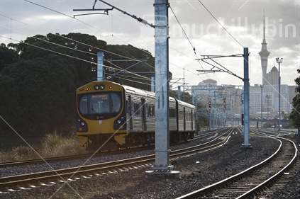 Passenger train leaving Auckland terminal, showing new electification wiring and poles