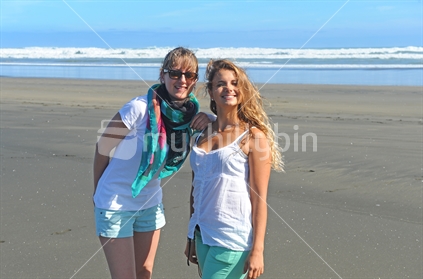 Two happy girls on West Coast beach (visitors from France).