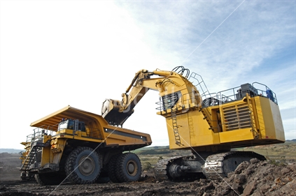 Heavy machinery loading coal