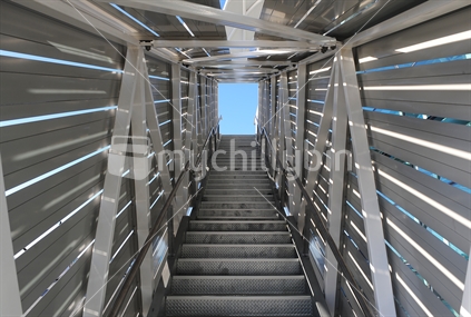 Steel staircase leading to the blue sky.