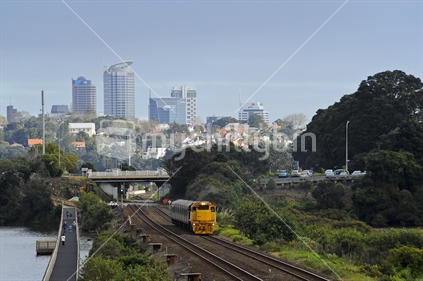 train leaving Auckland with City Background