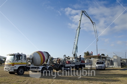 Concrete truck and concrete pump on construction site