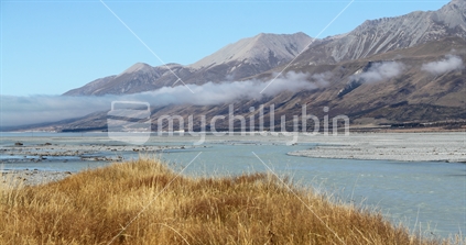 View across Tasman River estuary towards the western hills, with low cloud over the river