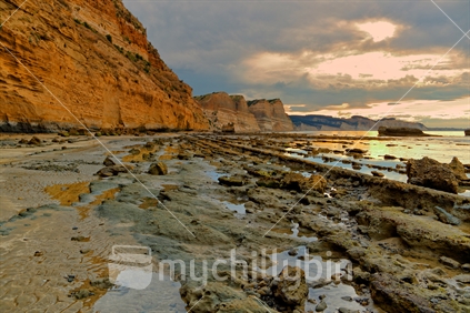 Strata on the shore outlined by the setting sun on the cliffs at Cape Kidnappers