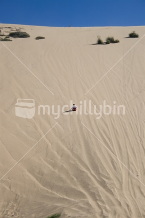 Sand tobogganing at Ahipara Northland