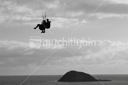 Tandem Para Gliding high above Maori Bay on the West Coast