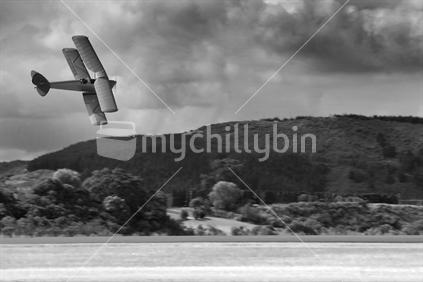 A Tigermoth biplane soars over the planes of what is now the Tauranga airport