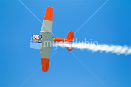 Smoke trail from WW2 acrobatic aeroplane, over New Zealand