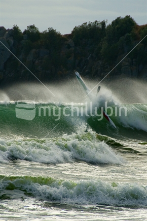 Kayak smashes through a wave on Maunganui Beach, New Zealand