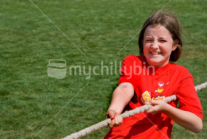 Girl pulls in a game of tug of war, New Zealand