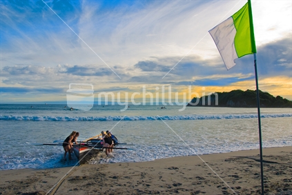 Surf boat team at day break, with Motiti Island out to sea;' Mount Maunganui.