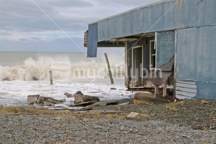 House being washed away by the sea, Hawkes Bay