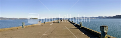 A panorama of Petone Wharf with people walking and fishing; on a calm Wellington day, New Zealand.