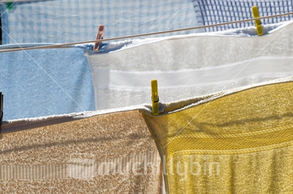 Towels hanging to dry in the sun on a clothes line