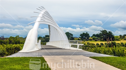 The architectureal Waiwhakaiho River bridge forming part of the Coastal walkway in New Plymouth taken on a cloudy day