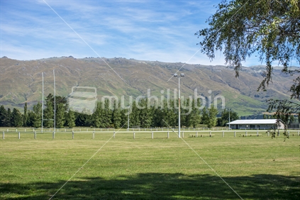 A country life rugby field and sports stadium in a small rural town, in this case Middlemarch in Otago with a backdrop of the Rock and Pillar mountain range. Close to the start of the Otago Rail trail