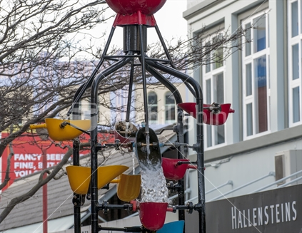 Scenes from Wellington's Cuba Street Quarter, a mix of quaint shops, funky people, quirky scenes and of course the famous bucket fountain showing a close up of the top half of the fountain as water splashes down to a lower bucket