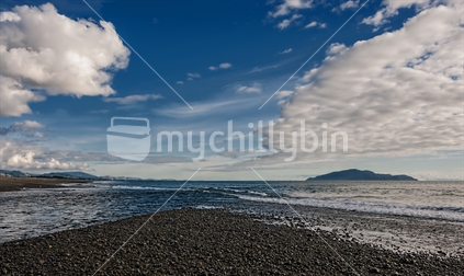 Where the Otaki River meets the Tasman Sea at the south end of Otaki beach. In the distance the hills and Kapiti Island. The clouds and river all provide nice lead in lines.