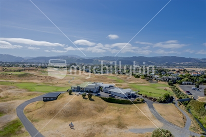 Paraparaumu golf course from an elevated position with Paraparaumu town and the Tararua hills in the backgrounf