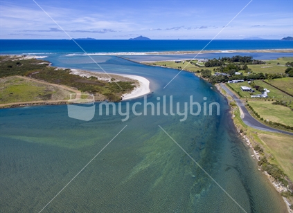 Aerial shot of The waipu River estuary. A fine blue sky day taken at high tide showing the clear waters of the river estuary and out to Bream Bay