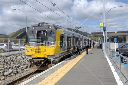 Waikanae New Zealand November 1 2019. At the Waikanae train station an electric rail car arrives and departs travelling to Wellington city. The guard stands beside the train.