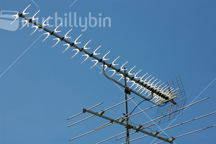 UHF sky aerial on a roof with a blue sky background
