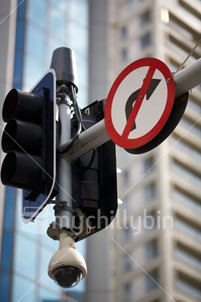 No right turn sign on a traffic light pole (with surveillance camera) in downtown Auckland.