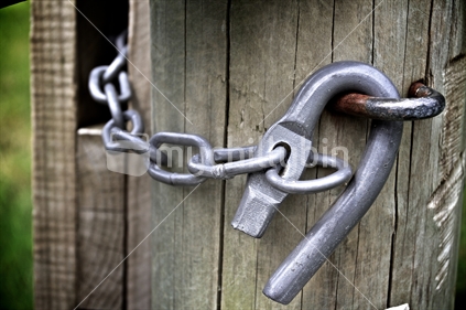 Latch and chain on a closed farm gate