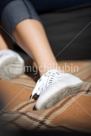 Girl's shoes on picnic mat with shallow depth of field 