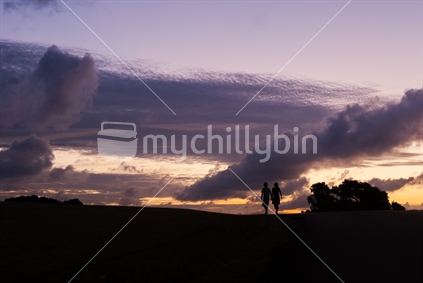 Young couple (motion blur) on an evening walk