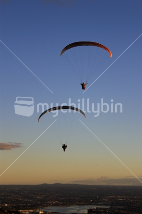 Paraglider against a sunset backdrop from Mount Maunganui, Tauranga, New Zealand