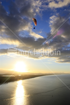 Paraglider against a Sunset Backdrop from Mount Maunganui, Tauranga, New Zealand