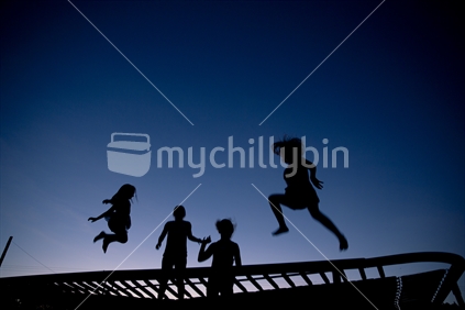 Four girls bouncing on trampoline 