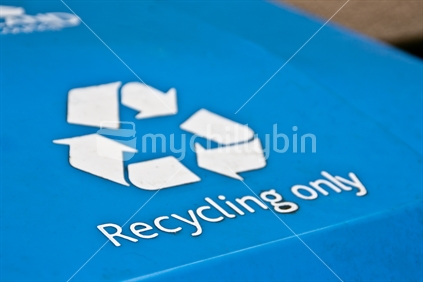 Closeup of an Auckland blue recycling bin dirty label - for recycling plastic and glass.