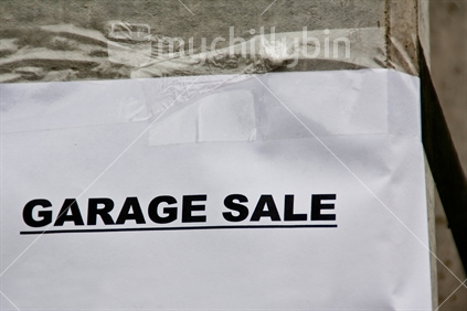 A garage sale sign, taped on a post